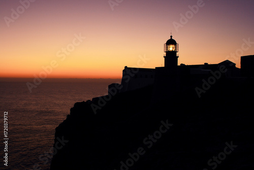 Portugal, Algarve Region, Sagres. The lighthouse at Cape Saint Vincent - Cabo Sao Vicente at dusk. The beacon on. Continental Europe's most South-western point.