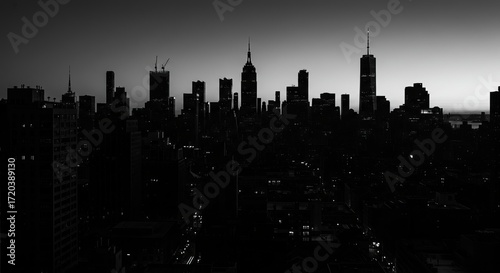 Dramatic New York City skyline silhouette at dusk, iconic skyscrapers creating a powerful urban landscape