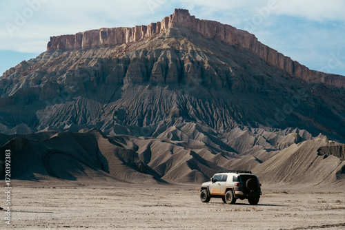 Fotografie Off-Road SUV Against Subtle Textures of Impressive Mountainous Backdrop