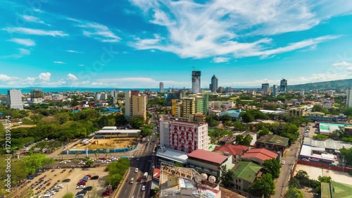 A vibrant cityscape unfolds under a bright blue sky in cebu, philippines