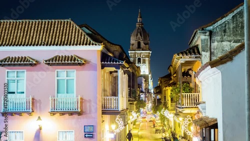 Street view of cartagena at night with illuminated buildings and decorations