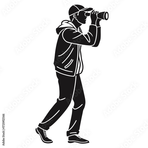 Photographer looking through binoculars silhouette