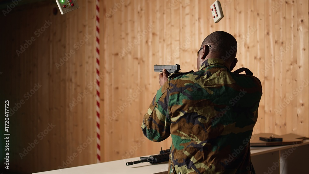 Fototapeta premium Soldier in shooting range reloads pistol, shooting target, celebrating after achieving perfect accuracy. Military unit in firing range practices with weapon, cheering after hitting bullseye, camera A
