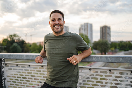 Papier peint Happy man smiling on city bridge portrait