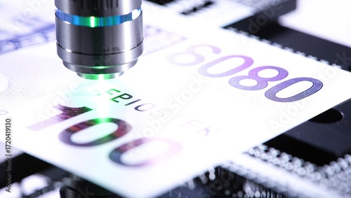 High-Powered Microscope Examining Security Features on Banknote