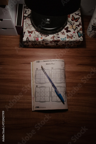 Sudoku and Pen on Wooden Desk