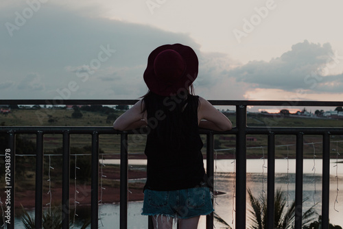 Young Woman with Hat Admiring Sunset