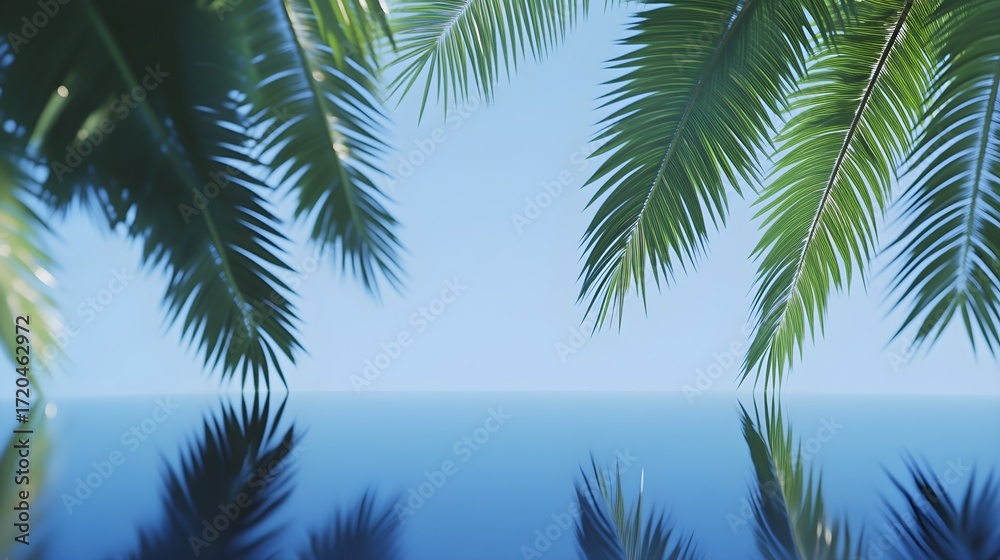 Naklejka premium Palm Fronds Overlapping Calm Blue Water Surface Keywords: palm trees, fronds, leaves, tropical