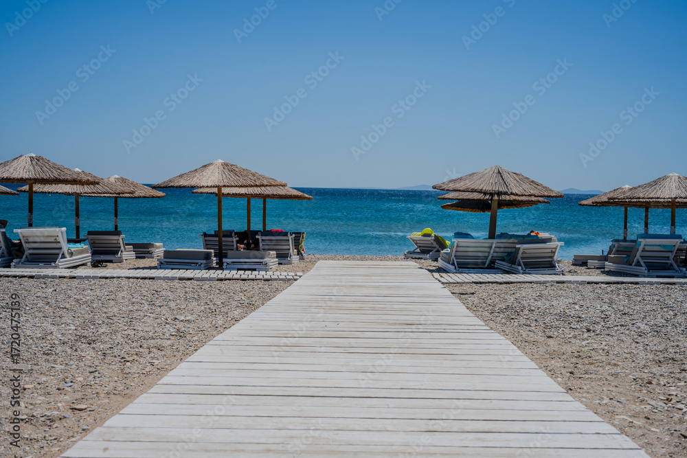 Fototapeta premium tropical beach with umbrellas and chairs