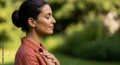 A woman finds inner peace through mindful meditation in nature. The woman is deeply relaxed and serene, demonstrating a connection with inner self