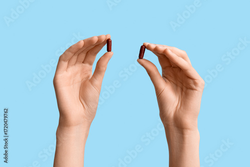 Female hands with pills on ...