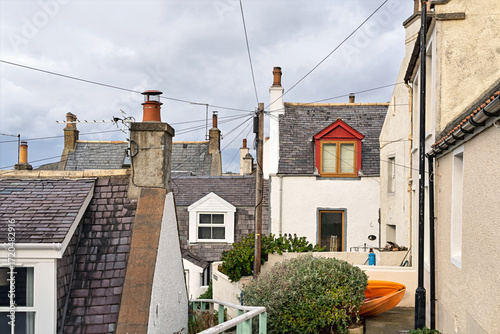 This is a view from a lane within the Old Fishing Village of Seatown at Gardenstown,Aberdeenshire in Scotland. In the centre can be seen a pole with many cables to feed the houses.