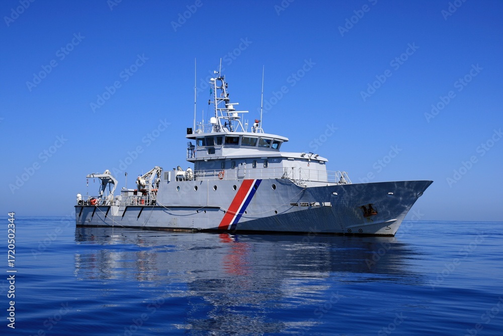 Naklejka premium Vessel Kermorvan in open waters, a beautiful French Customs patrol boat built by the Socarenam shipyards in Boulogne-sur-Mer, the Kermorvan entered service in 2008.