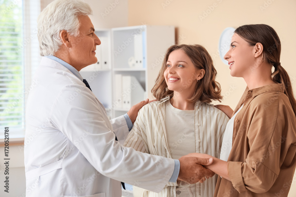 Fototapeta premium Young lesbian couple visiting fertility doctor about IVF in clinic