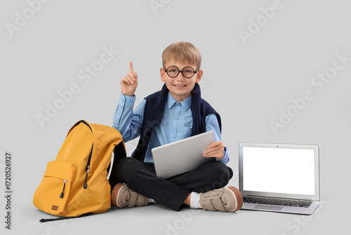 Little schoolboy with table...