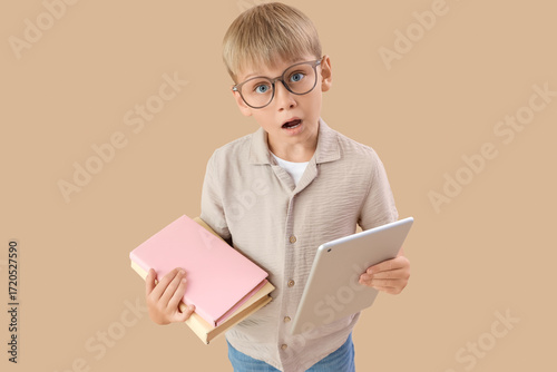 Shocked little boy with tab...