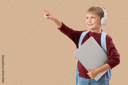 Little schoolboy in headpho...