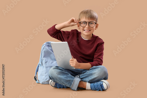 Little schoolboy with table...