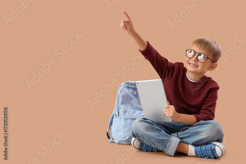 Little schoolboy with table...