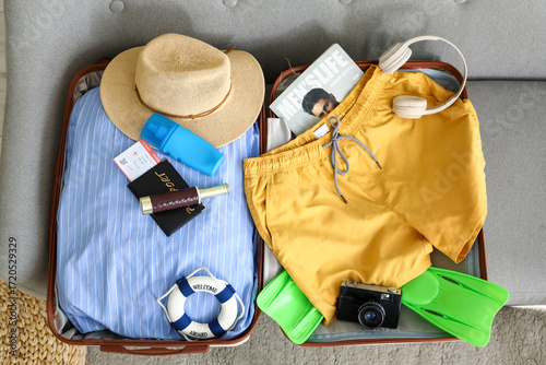 Open suitcase with men's sw...