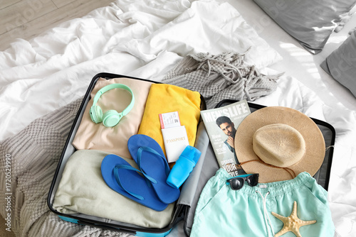 Open suitcase with men's sw...