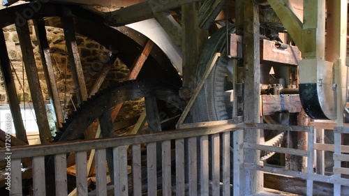 Waterwheel of a flour watermill. Traditional mechanical wooden wheel and gear.