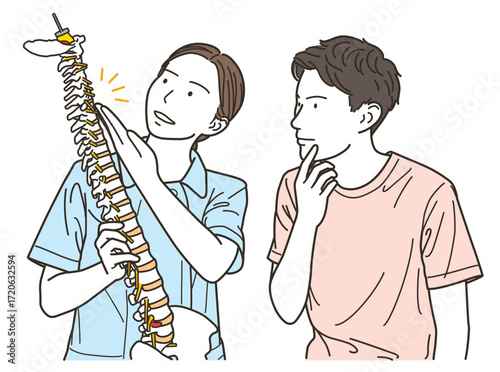 女性整体師が患者に背骨を使って説明する