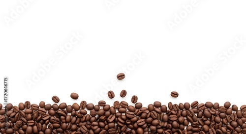 A pile of aromatic roasted coffee beans isolated on a clean white background forming a bottom border with copy space for text