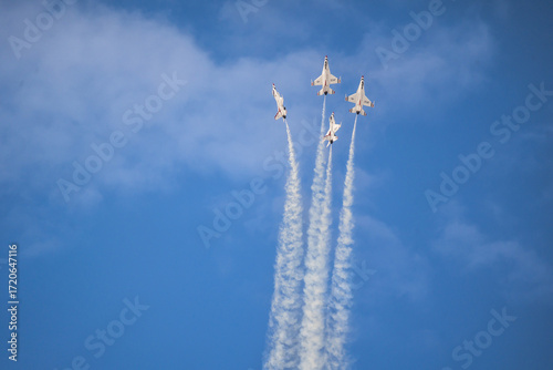 Air show planes flying in formation in blue sky