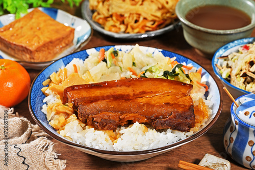 Braised pork belly rice is a beloved Taiwanese dish featuring a thick slice of soy-braised pork belly served over steamed white rice.