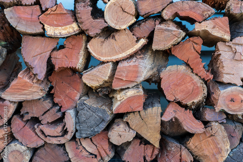 Wallpaper Mural Stack of freshly cut and split firewood. Close-up, against a blue background.  Torontodigital.ca