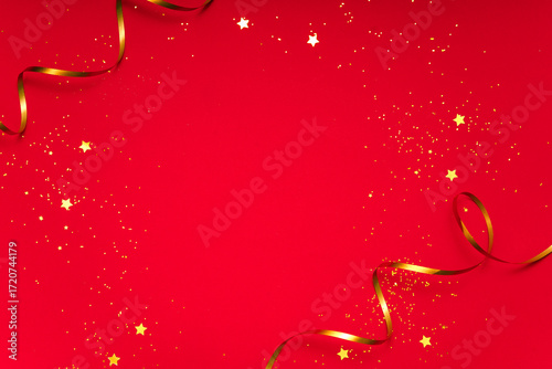 Shiny red christmas background with gold ribbon, glitter confetti and stars. Wide copy space template for poster, banner or social media promo.