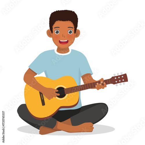 African man playing guitar sitting on the floor
