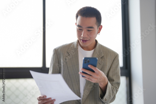 Asian Businessman with Smartphone working mobile devices cell telephone technology e-commerce smartphone business professional investor working new start up project