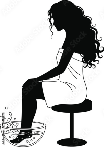 Relaxing silhouette of a woman enjoying a soothing foot bath, a moment of self-care and tranquility.