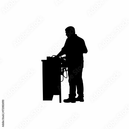 Silhouette of it worker organizing tangled computer wires behind a desk
