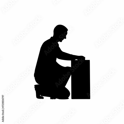 Silhouette of a technician crouching and fixing a computer cpu tower