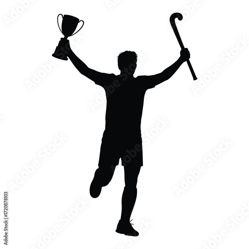 Silhouette of a triumphant hockey player holding a trophy and stick