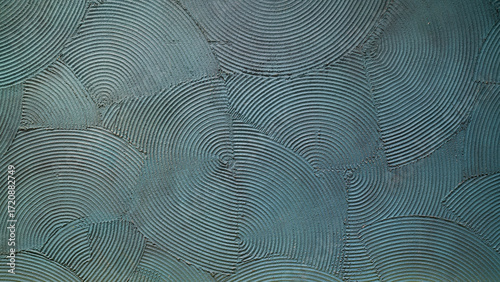 Sophisticated teal textured wall creates a modern, artistic vibe for interior design projects looking for unique backgrounds or stylish surface concepts