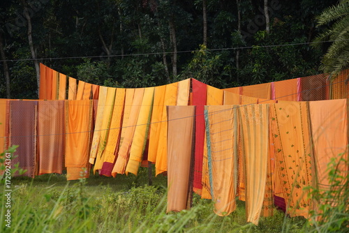 Colorful Fabrics Drying on Clotheslines in Rural Landscape