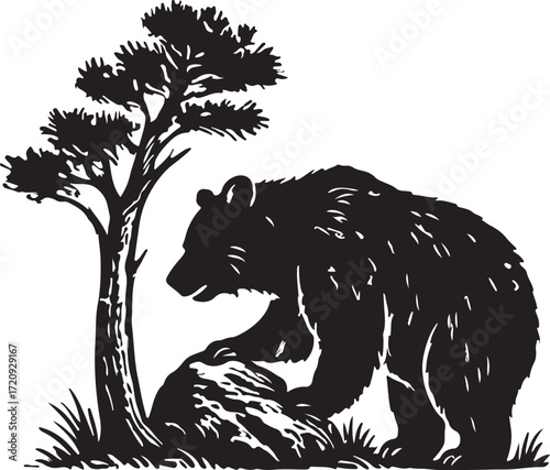 Black silhouette of a bear reaching for a rock next to a pine tree in a natural outdoor setting