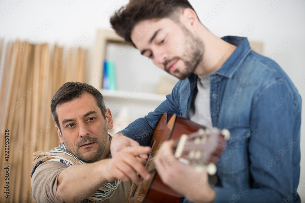 Fototapeta premium man learning to play the guitar