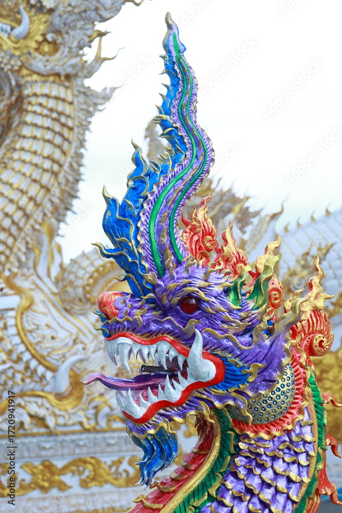 Fototapeta premium Thai-style purple Naga pattern architecture in front of the ordination hall of a temple.