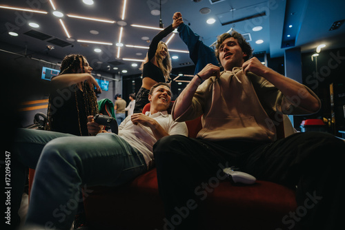 Friends gathering at a gaming lounge, engaged in video game activities, sharing fun moments, and creating joyful memories. Displaying excitement and teamwork in a vibrant indoor atmosphere.