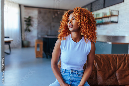 Woman sitting on her couching posing