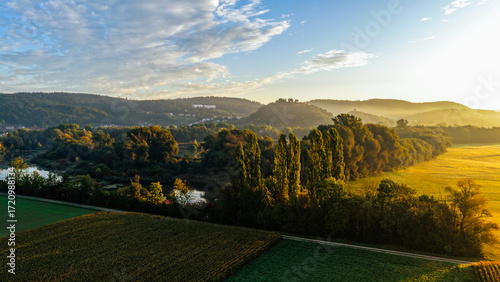 Morning Light Over Lush Forest, Fields and Hillside Village