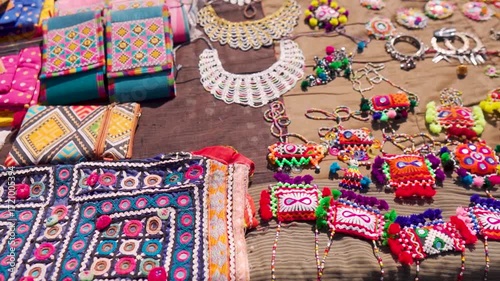 Close up shot of handicraft clothes, handbags and handmade jewelry from Rann Utsav market in Kutch, Gujarat, India. Beautiful Kutchi Handicraft arctician designer cloth in local street market.  