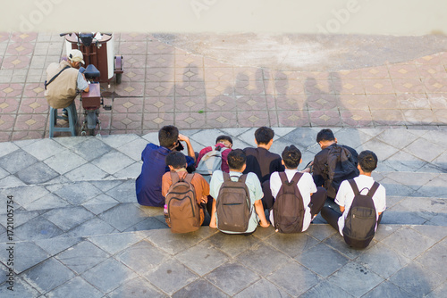 Portrait of a group of high school students and a drink vendor in the park, rear candid shot taken from above,