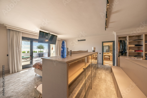 Photos Luxurious modern bedroom with ocean view and walk-in closet leading to a terrace