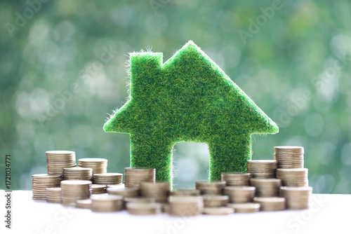 Mortgage,Model house and stack of coins money on natural green background,Business investment and real estate concept